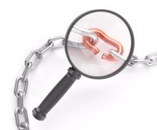 Broken Chain Link with Magnifying Glass